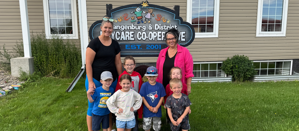 Community members joining hands together in a park